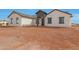 Stylish single-story home with a welcoming entrance, neutral colors, and well-maintained gravel landscaping at 25846 W Denver Hill Dr, Wittmann, AZ 85361
