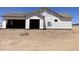 Newly built home with visible garage doors and under construction, offering a glimpse of future potential at 25846 W Denver Hill Dr, Wittmann, AZ 85361