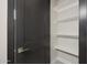 Hall closet with shelving for storage, located next to a dark interior door at 25846 W Denver Hill Dr, Wittmann, AZ 85361