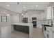Bright, modern kitchen featuring white cabinets, stainless appliances, and a gray island with quartz countertops at 25846 W Denver Hill Dr, Wittmann, AZ 85361