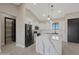 Bright, modern kitchen with white cabinets, stainless appliances, and a gray island with quartz countertops at 25846 W Denver Hill Dr, Wittmann, AZ 85361