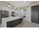 Contemporary kitchen features a waterfall island, stainless steel appliances, and plenty of cabinet space at 25846 W Denver Hill Dr, Wittmann, AZ 85361