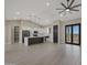 Bright, open-concept kitchen with white cabinets, stainless appliances, and a gray island with quartz countertops at 25846 W Denver Hill Dr, Wittmann, AZ 85361