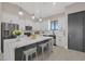 Modern kitchen features a large island, stainless steel appliances, and ample white and gray cabinetry at 25846 W Denver Hill Dr, Wittmann, AZ 85361