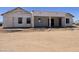 Back of a new construction home with a covered patio area, presenting a blank canvas for personalization at 25846 W Denver Hill Dr, Wittmann, AZ 85361