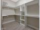 A large walk-in closet providing an abundance of shelving and hanging storage at 25846 W Denver Hill Dr, Wittmann, AZ 85361