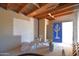 Unfinished basement with exposed wood ceiling, concrete walls, and a unique blue door featuring a cactus design at 2815 W Ohio St, Apache Junction, AZ 85120
