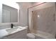 Bright bathroom featuring modern vanity with marble countertop, white tiled walls and shower at 2815 W Ohio St, Apache Junction, AZ 85120