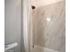 Close up on bathroom wall with shower head and marble tiled walls at 2815 W Ohio St, Apache Junction, AZ 85120