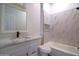 Bright bathroom featuring modern vanity with marble countertop, white tiled walls and shower at 2815 W Ohio St, Apache Junction, AZ 85120
