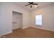 Bright bedroom featuring a ceiling fan and closet with shelving at 2815 W Ohio St, Apache Junction, AZ 85120