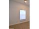 Bedroom with neutral carpet and bright window with shades at 2815 W Ohio St, Apache Junction, AZ 85120