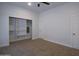 Spacious bedroom with plush carpet, ceiling fan, and closet space at 2815 W Ohio St, Apache Junction, AZ 85120