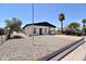 Quaint home featuring desert landscaping, a covered carport, and a driveway for parking at 2815 W Ohio St, Apache Junction, AZ 85120