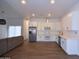Stylish kitchen with white cabinets, stainless steel appliances, and an open floor plan at 2815 W Ohio St, Apache Junction, AZ 85120