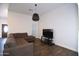 Spacious living room featuring a large sectional couch, wood floors, modern lighting and ample natural light at 2815 W Ohio St, Apache Junction, AZ 85120
