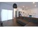 Open floor plan living room with wood floors, modern lighting, and stainless steel appliances at 2815 W Ohio St, Apache Junction, AZ 85120
