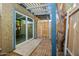 Charming backyard showcasing a covered patio, glass sliding door, and wooden fence at 286 W Palomino Dr # 147, Chandler, AZ 85225