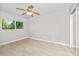 Bright bedroom with a ceiling fan, large window and closet with mirrored doors at 286 W Palomino Dr # 147, Chandler, AZ 85225