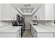 Efficient kitchen design with white cabinets, stone countertops, and stainless steel appliances at 286 W Palomino Dr # 147, Chandler, AZ 85225