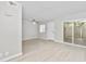 Living room features wood-look floors, neutral paint, and sliding glass doors at 286 W Palomino Dr # 147, Chandler, AZ 85225