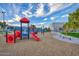 Colorful community playground with slides, climbing structures, and a soft landing surface at 286 W Palomino Dr # 147, Chandler, AZ 85225
