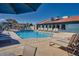 Community swimming pool with lounge chairs and a vibrant blue building backdrop at 286 W Palomino Dr # 147, Chandler, AZ 85225