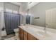 Bathroom with double sinks, large mirror, tub/shower combination, and tile flooring at 2976 E Clifton Ave, Gilbert, AZ 85295