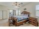 Bedroom featuring a king size bed, wooden furniture, carpet and natural light from the window and patio doors at 2976 E Clifton Ave, Gilbert, AZ 85295