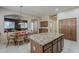 Spacious kitchen has a center island and is open to the adjacent dining and living areas, great for hosting at 2976 E Clifton Ave, Gilbert, AZ 85295