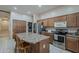Functional kitchen boasts stainless steel appliances, a large island with seating, and plenty of cabinet space at 2976 E Clifton Ave, Gilbert, AZ 85295
