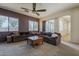 Spacious living area with plush sofas, a dark accent wall, and large windows offering plenty of natural light at 2976 E Clifton Ave, Gilbert, AZ 85295