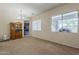 Spacious living room featuring neutral carpet, hutch, and bright windows providing ample natural light at 2976 E Clifton Ave, Gilbert, AZ 85295