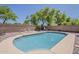 Refreshing backyard pool with lounge chairs and privacy fence is perfect for outdoor relaxation at 2976 E Clifton Ave, Gilbert, AZ 85295