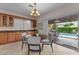 Bright dining area with chandelier and sliding glass doors to backyard with pool view at 3018 E Vernon St, Gilbert, AZ 85298