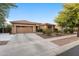 Charming single-story home featuring a well-kept yard, neutral stucco siding, and a spacious two-car garage with a long driveway at 3018 E Vernon St, Gilbert, AZ 85298