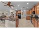 Open-concept kitchen features tile flooring, wood cabinets, granite counters, and stainless steel appliances at 3018 E Vernon St, Gilbert, AZ 85298
