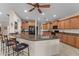 Spacious kitchen features a granite countertop island with seating, stainless steel sink, and wood cabinetry at 3018 E Vernon St, Gilbert, AZ 85298