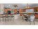 Large kitchen features a central island, dining area, granite countertops and stainless appliances at 3018 E Vernon St, Gilbert, AZ 85298