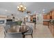 Open living space showcasing kitchen, dining area, and living room with fireplace and a chandelier at 3018 E Vernon St, Gilbert, AZ 85298