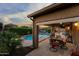 Inviting covered patio with dining, lounge area, and a pool for relaxing and entertaining at 3018 E Vernon St, Gilbert, AZ 85298