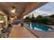 Spacious covered patio featuring outdoor seating, fans, and a view of the pool and spa at 3018 E Vernon St, Gilbert, AZ 85298