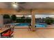 A covered patio offers a view of the pool and spa, equipped with fans for air circulation at 3018 E Vernon St, Gilbert, AZ 85298