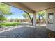 A covered patio providing shade for an outdoor dining set and overlooking the backyard at 31259 N 42Nd Pl, Cave Creek, AZ 85331