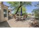 Paver patio with outdoor dining set, shaded by a mature tree, and overlooking the backyard pool at 31259 N 42Nd Pl, Cave Creek, AZ 85331