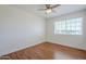 Clean bedroom with hardwood floors, white walls and trim, and view of greenery through window at 31259 N 42Nd Pl, Cave Creek, AZ 85331