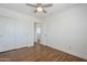 Simple bedroom with a ceiling fan, hardwood floors, and access to hallway at 31259 N 42Nd Pl, Cave Creek, AZ 85331