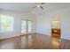 Bright bedroom with hardwood floors, ceiling fan, and access to a balcony with an ensuite bathroom at 31259 N 42Nd Pl, Cave Creek, AZ 85331