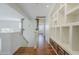 Bright hallway with hardwood floors, built-in shelving and decorative stone accents at 31259 N 42Nd Pl, Cave Creek, AZ 85331