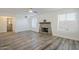 Open living room featuring a stone fireplace, wood-look tile flooring, and access to a bathroom at 31259 N 42Nd Pl, Cave Creek, AZ 85331